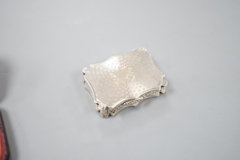 An early Victorian engine turned silver shaped rectangular vinaigrette, by Nathaniel Mills, Birmingham, 1843, 36mm, in leather box.